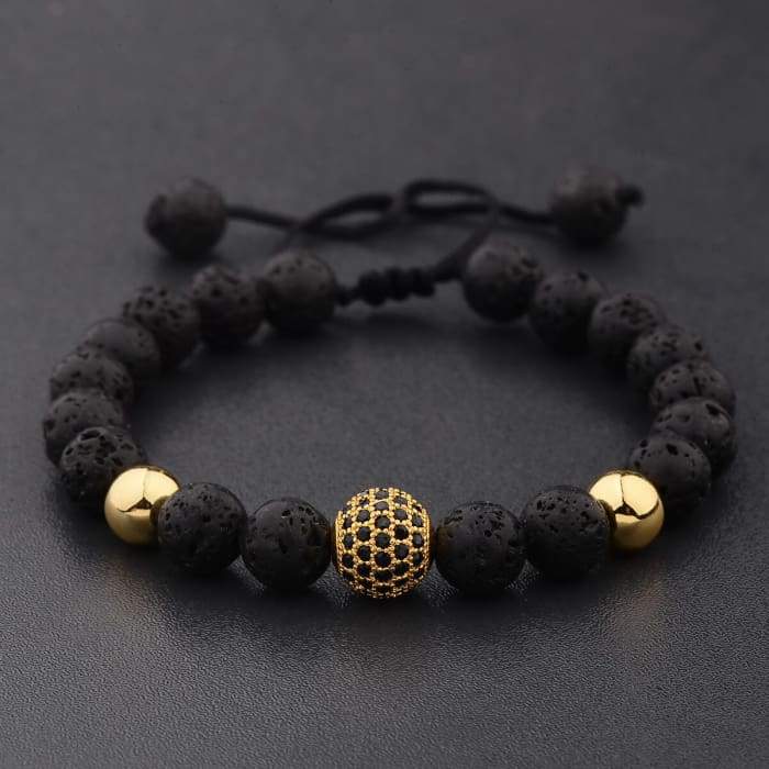 Bracciale in pietra lavica dorata con sfera di cristallo